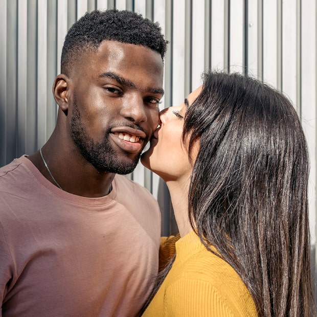 woman kissing man's cheek smiling how to kiss a guy
