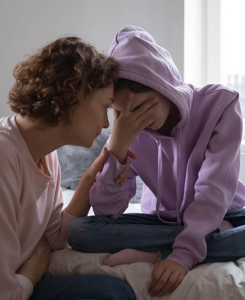 parent comforts upset teen