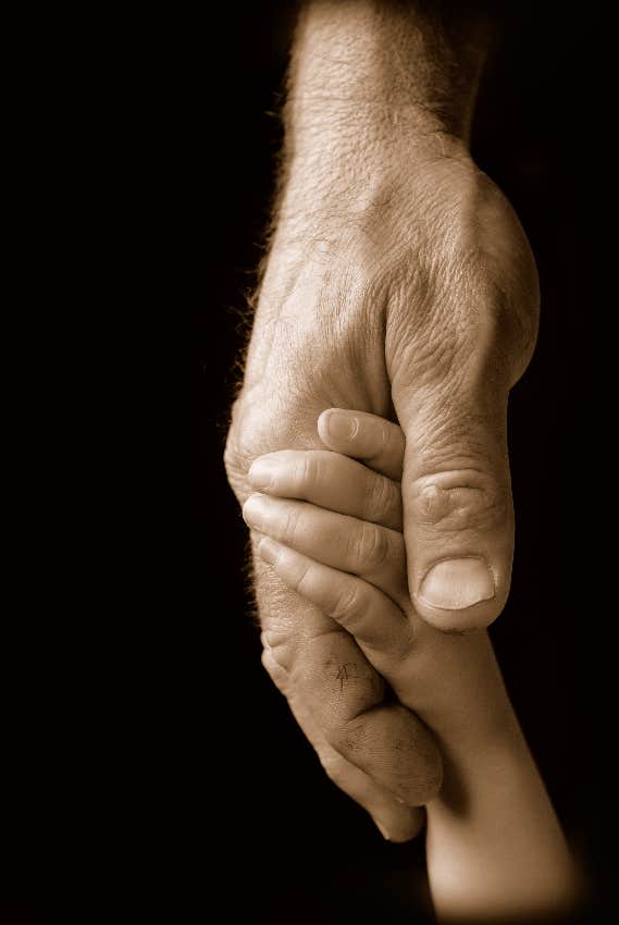 young child holding adult's hand